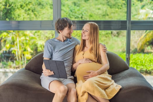 A smiling husband and his pregnant wife share a moment of joy, gazing at a tablet screen, their faces glowing with anticipation and happiness