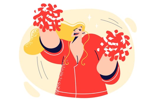 Woman cheerleader waves hand with pompoms and dances festive dance to motivate athletes to play well