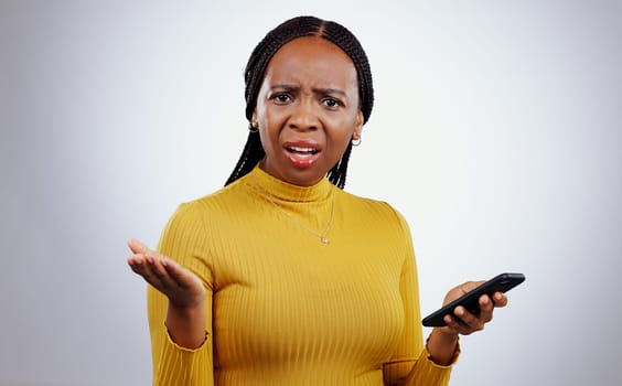 Phone text, black woman and confused portrait from scam conversation and anxiety from problem and fail. Studio, white background and frustrated female person with spam communication and mistake