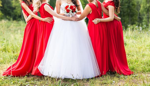 Bride with bridesmaids outdoors on the wedding day