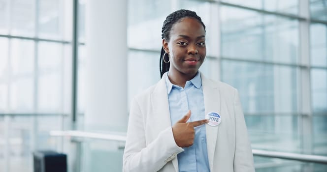 Woman, portrait and badge for vote, pointing and confidence or button, proud and choice in politics. Black person, pin and support for elections, democracy and party in registration for human rights