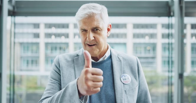 Senior man, thumbs up and politician for vote, thank you and feedback on choice, decision and politics. Mature person, wink and support in review, agreement and motivation to register for election