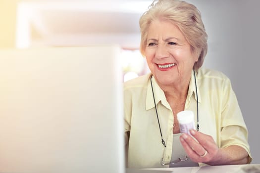Checking her prescription details online. a senior woman researching her medication online.