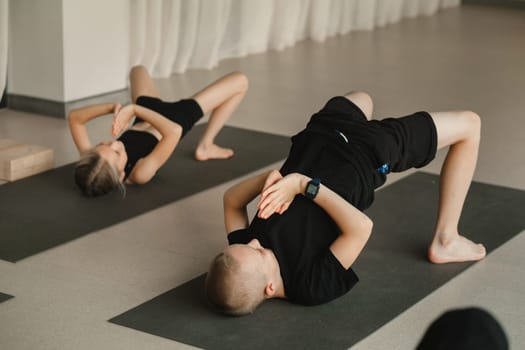 Children do Yoga in the fitness room. Children's gymnastics
