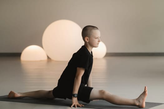 A child practices yoga poses indoors. Children's yoga