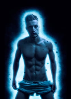 Photo of a shirtless man standing in front of a vibrant blue light