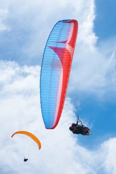 Sailing through the sky. two people paragliding on a sunny day