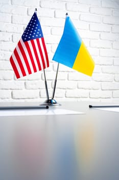 USA and Ukraine flags on negotiation table