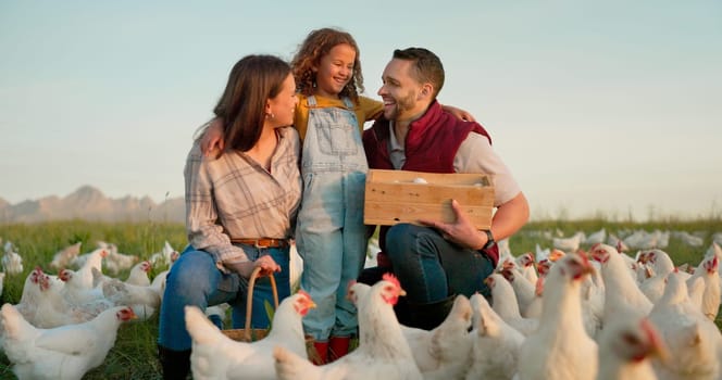 Parents, girl and hug with chicken, farm and happy with box for food, sustainability and talk in sunshine. Father, mother and daughter with poultry, countryside and environment with smile for birds