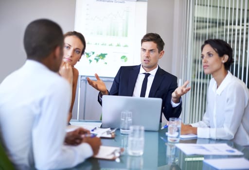 Corporate conundrums. A group of businesspeople having a heated discussion in the boardroom.
