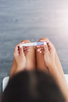 Are you ready for motherhood. an unrecognizable woman taking a pregnancy test at home.