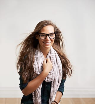 Portrait, happy and woman in glasses in home, house or apartment wall for fashion. Face, eyewear and smile of girl, model or attractive person in stylish scarf, cool clothes and mockup in Switzerland