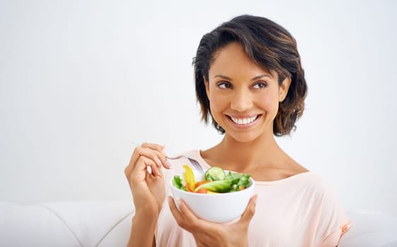 Happy, health and young woman with a salad at home with vegetables for wellness, organic or diet. Smile, nutrition and female person from Mexico eating healthy meal with produce in living room.