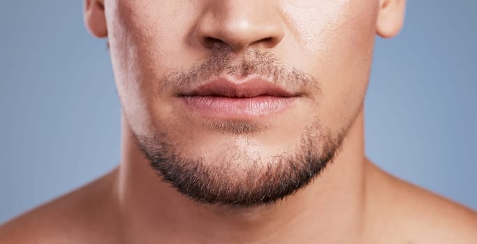 Should I grow it out or shave it. a man posing against a grey background.