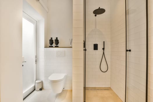 a white bathroom with a toilet and a shower