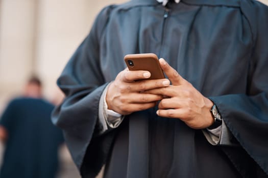 Lawyer, hands and cellphone with judge for justice at courtroom in city for communication or research. Tech, legal and advice with advocate for consulting on mobile app for client with an attorney.