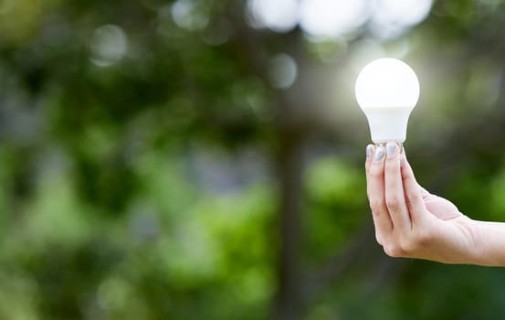 Nature, hand and lightbulb for knowledge, energy or sustainability with solar power. Creative, innovation and person with bulb for eco friendly electricity, green solution or inspiration with mockup
