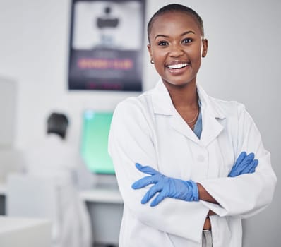 Scientist, black woman and happy in portrait, arms crossed with medical research and science study in laboratory. African female doctor, pathology or biotech, scientific experiment and confidence