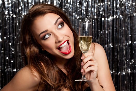 Its never too late to celebrate. a beautiful woman celebrating with a glass of champagne against a studio background.