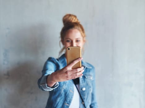 Selfie, influencer and woman on social media with phone in hand, smile and wall background. Happy face of young content creator, digital photography and girl streaming video with online mobile app.