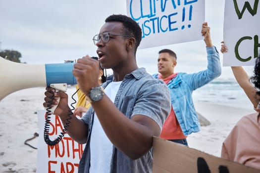 Protest, climate change and megaphone with black man at the beach for environment, earth day and action. Global warming, community and pollution with activist for social justice, support and freedom