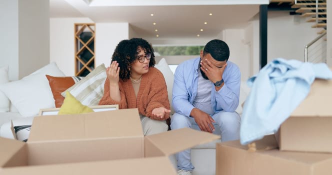 New home, box and frustrated couple on sofa for house, property investment and moving day. Conflict, argue and man and woman with crisis, problem and fight for mortgage, rent and real estate purchase