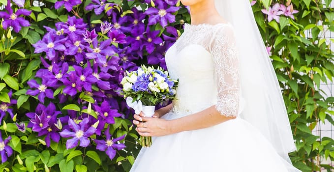 Beautiful wedding bouquet in hands of the bride close-up