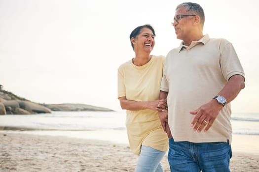 Smile, walking and senior couple at the beach happy, relax and bond in nature together. Love, embrace and old people at the sea for travel, vacation and enjoy retirement with holiday, freedom or walk
