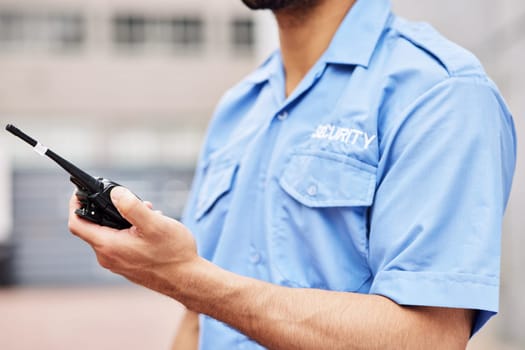 Walkie talkie, man and hands of security guard for safety, justice and call backup in city. Closeup of police officer, bodyguard and contact on radio communication, crime watch and urban surveillance