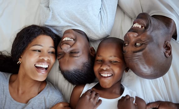 I sustain myself with the love of family. a beautiful young family bonding in bed together.