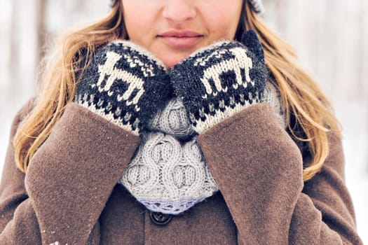 Closeup of young woman in wintertime outdoor. Snow and cold