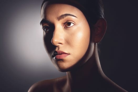 I have a routine thats dedicated to face time. Studio shot of a beautiful young woman posing with light beam against her face.