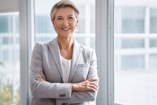 Business woman, portrait or arms crossed by window in corporate financial, investment company or insurance office. Smile, happy or confident mature ceo in about us with success mindset for management