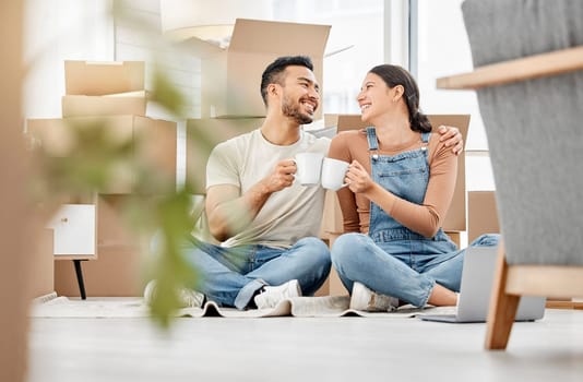 Im so lucky to be making this new start with you. a young couple sitting on the floor and drinking coffee while moving house.