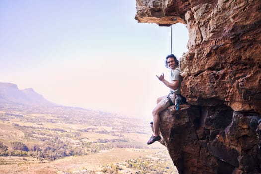 Rock climbing, shaka and portrait with man on mountains for sports, space and adventure. Nature, exercise and travel with person training on cliff for rope, challenge and performance mockup