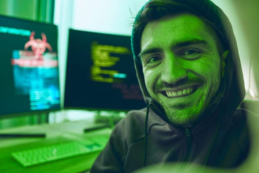 Cybersecurity, crime and smile, portrait of hacker in neon office with code, fraud and virus. Software, ransomware and face of happy man on cyber attack, password thief and online scam with computer.