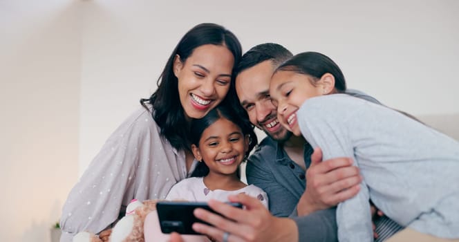 Happy family selfie, parents and kids in bedroom, hug and bonding together for love or memory in home. Photography, support and mom, dad and children on bed with smile, relax playful fun in house.