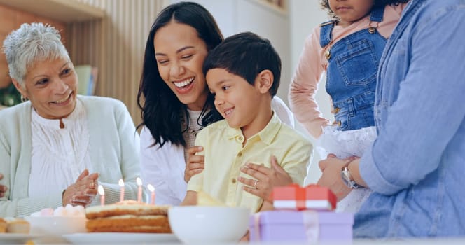 Child with birthday cake, candles and big family to celebrate with smile, fun and love together in home. Happiness, gift and congratulations, mom and grandparents at kids party with excited children.