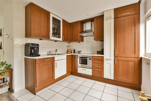a kitchen with wooden cabinets and a white tile floor