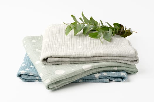 Three folded cotton blankets on white background