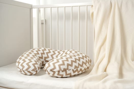 White wooden baby crib in nursery room