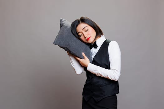 Tired waitress sleeping on pillow