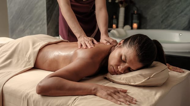 Asian woman getting a Thai massage in a Massage room in Thailand at a luxury hotel