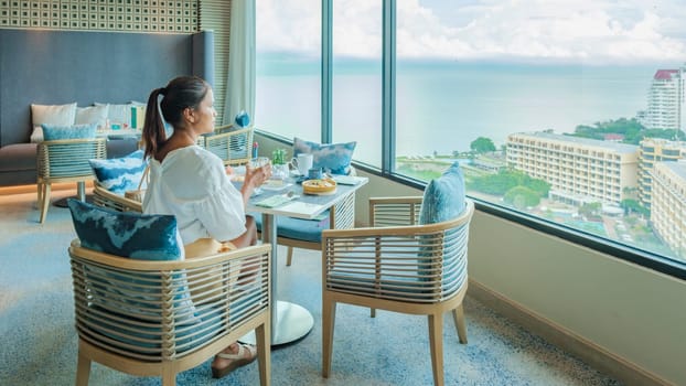 Asian Thai woman eating breakfast in a luxury hotel in Thailand