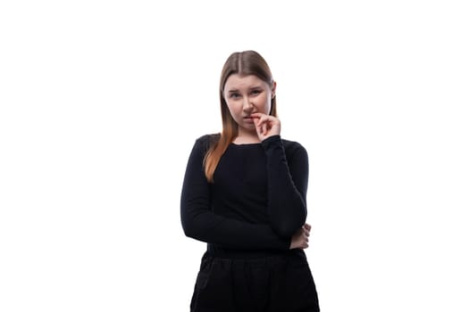 Portrait of a cute Caucasian pre-teen girl wearing a black turtleneck on a white background