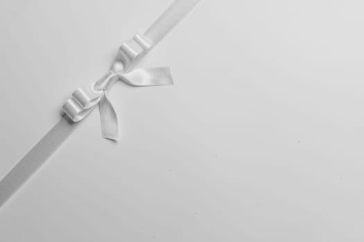 White ribbon bow on gray
