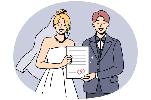 Smiling bride and groom hold marriage certificate