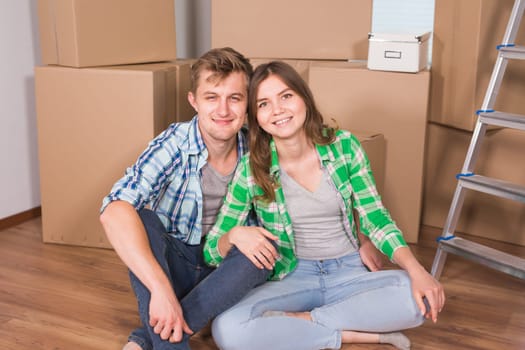 Home, people, moving and real estate concept - Portrait of happy couple in new home