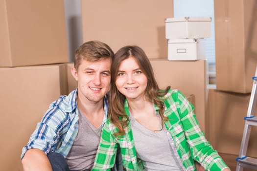 Home, people, moving and real estate concept - Portrait of happy couple in new home