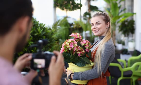 Happy Vlogger Posing with Flower to Camera Man
